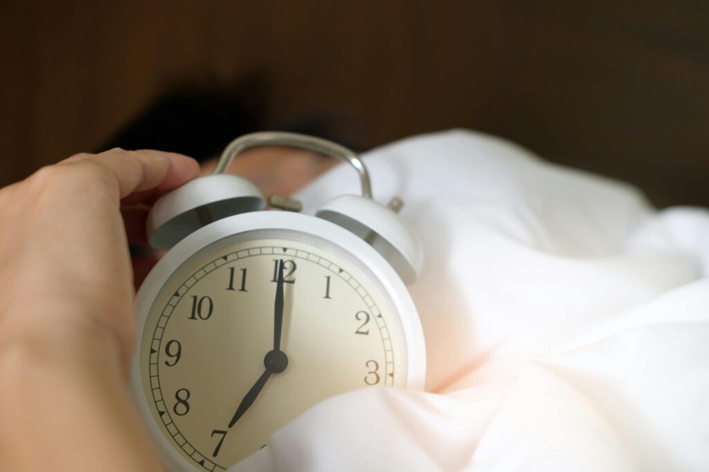 Person turning off lamp as part of sleep routine